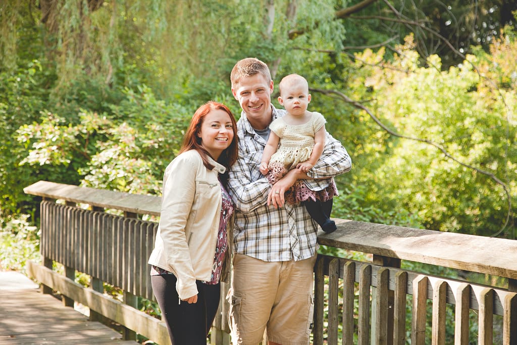 parents and toddler on bridge in beige colour palette